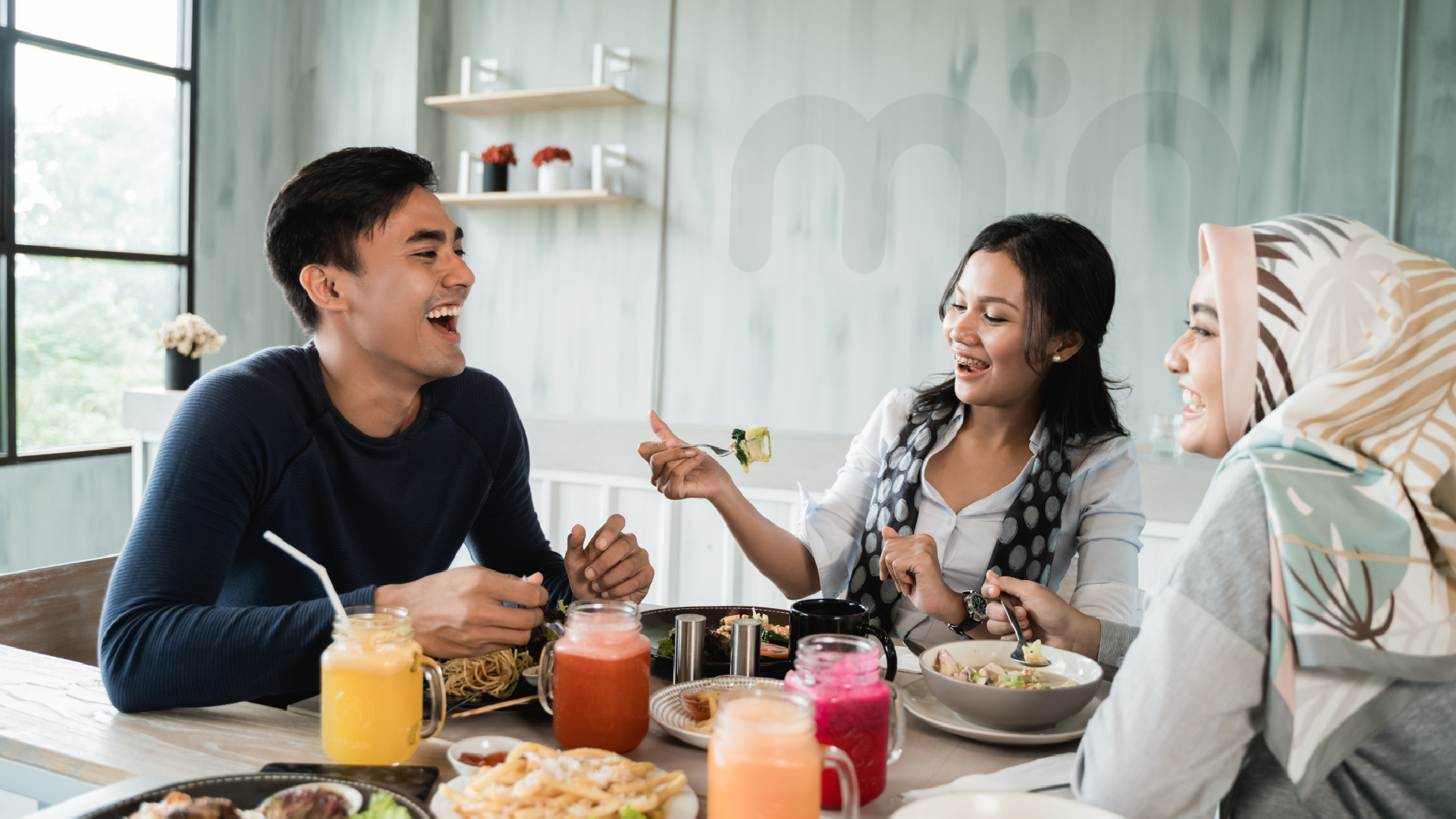 a group of friends of different races having a great meal together